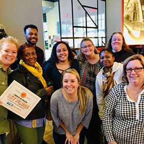 Employees standing together for photo