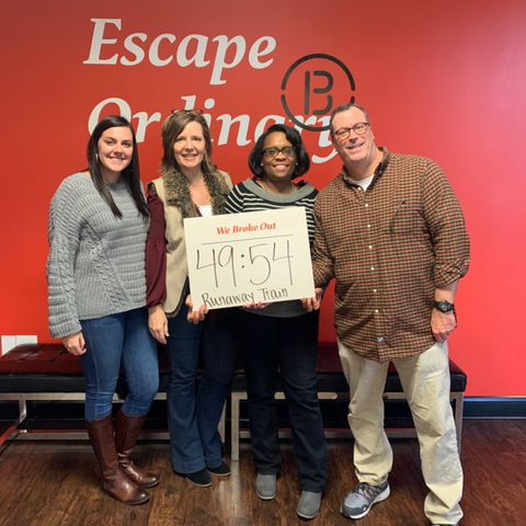 Employees completing an escape room together