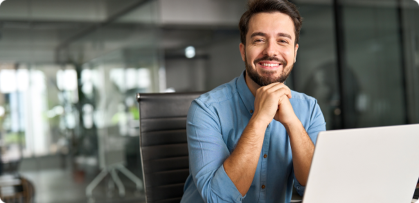 smiling man at a laptop